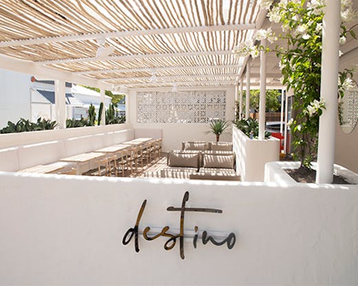 a stunning white timber deck surrounded by a white wall on which is written 