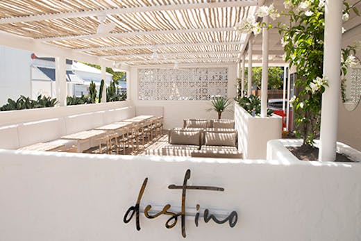 a stunning white timber deck surrounded by a white wall on which is written