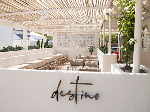 a stunning white timber deck surrounded by a white wall on which is written 