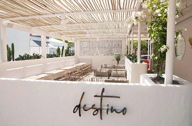 a whitewashed outdoor timber deck of a wine bar