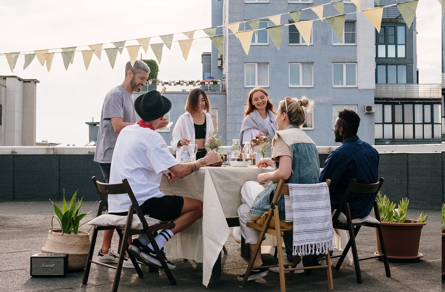 A group of people at a rooftop dinnerparty.