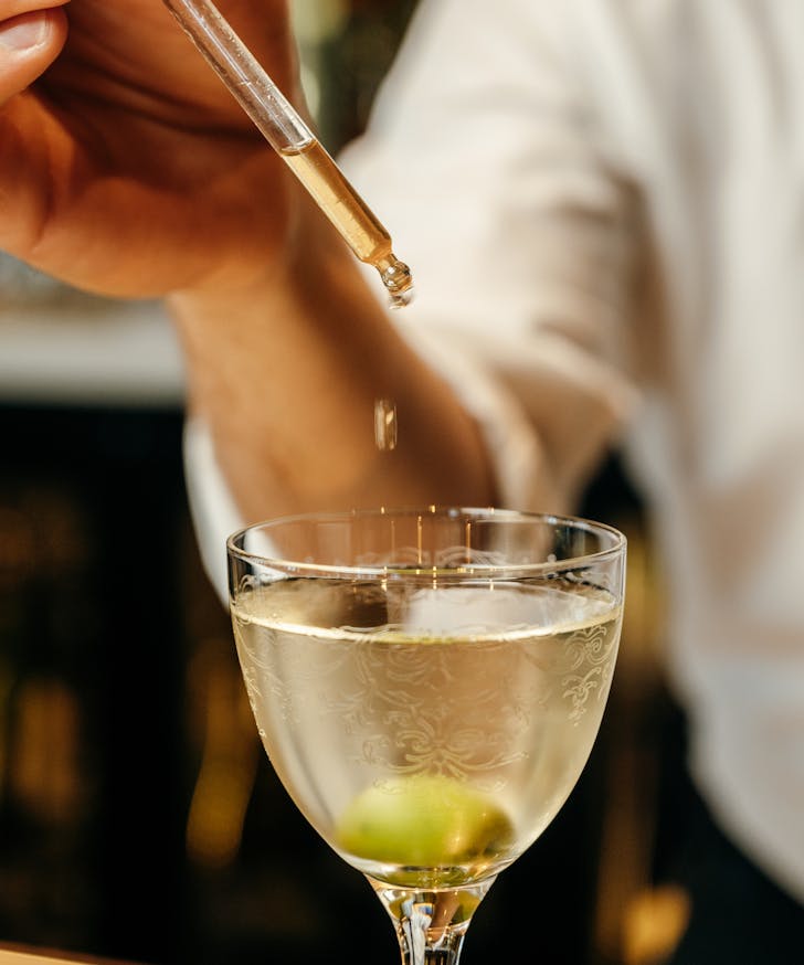 drops of olive on a dirty martini