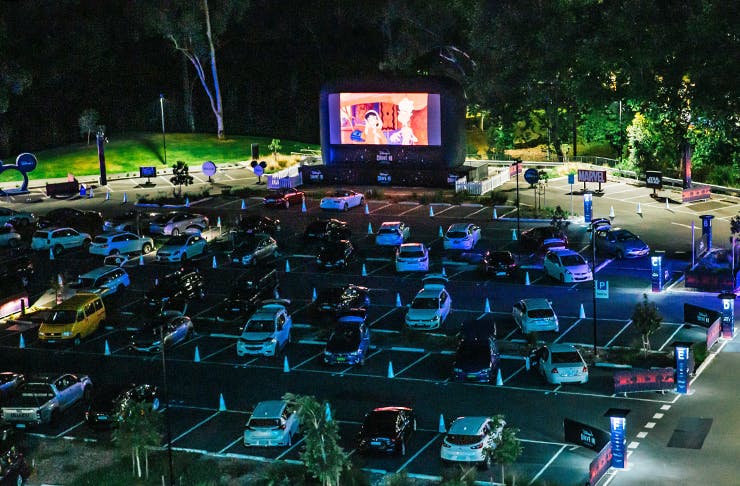 A drive in cinema at night.