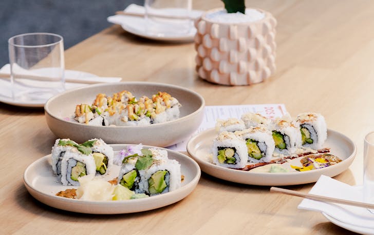 three plates of sushi on a table