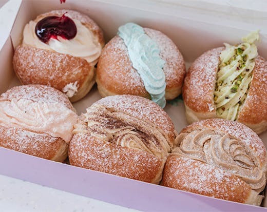 A box of six doughnuts with different fillings