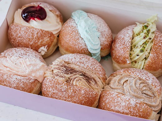 A box of six doughnuts with different fillings