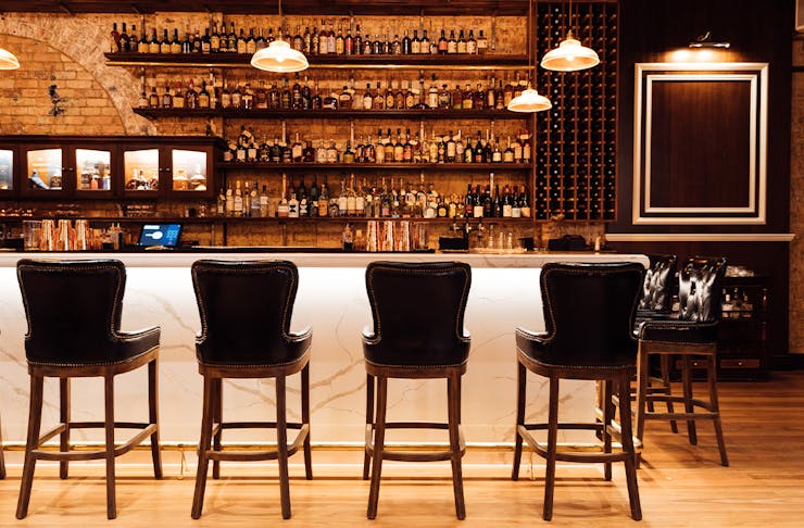 a long bar with high stools along it