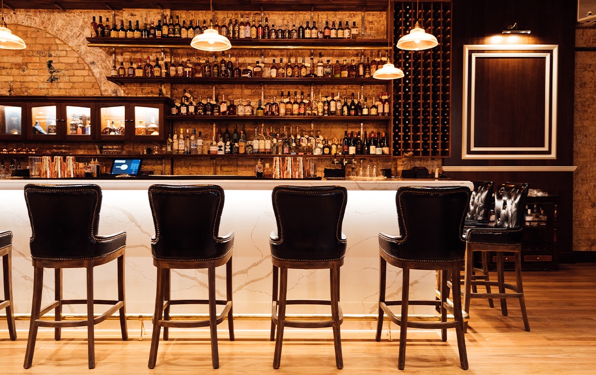 a long bar with high stools along it