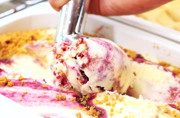 Boysenberry cheesecake ice cream is scooped