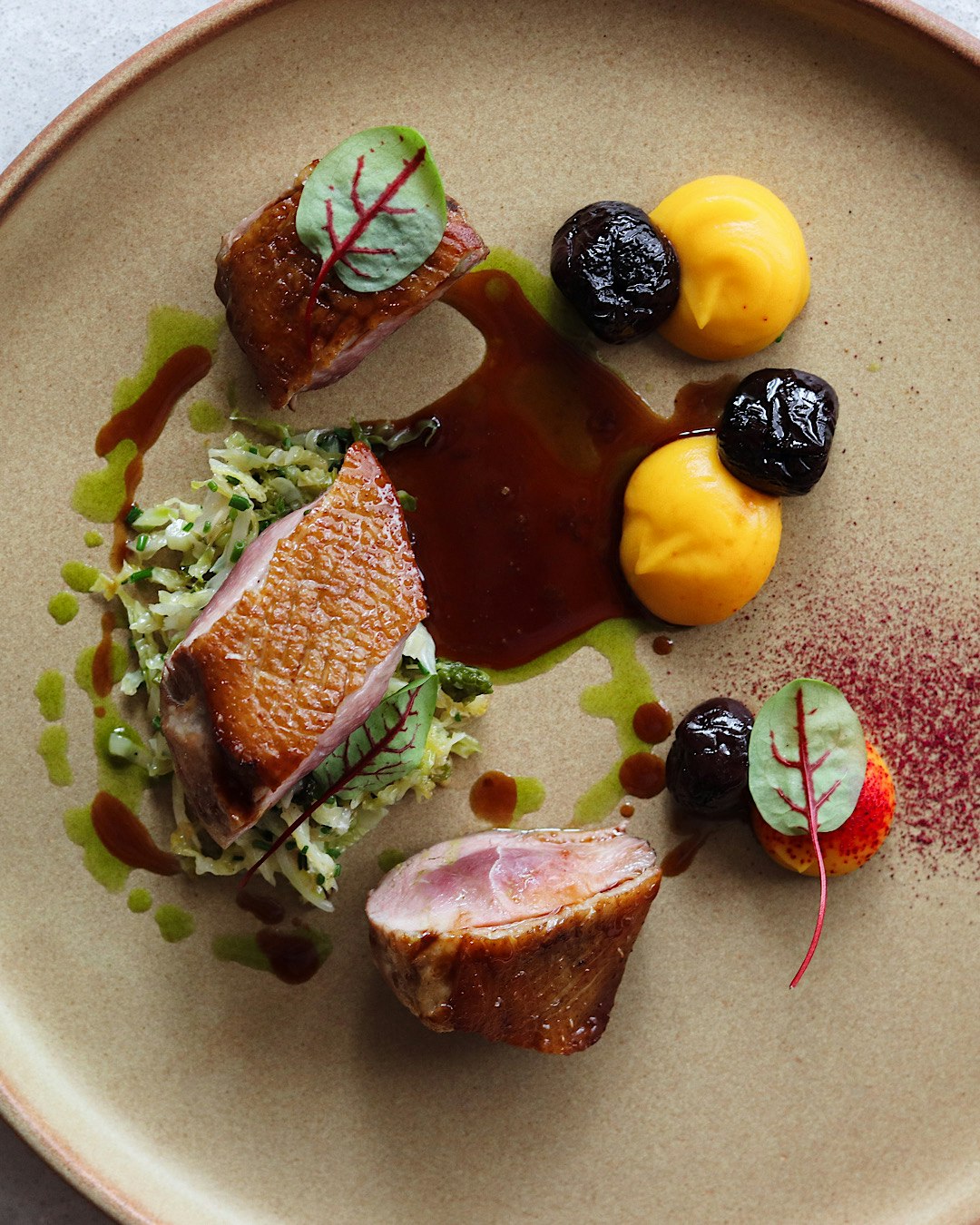 Duck breast with butternut and poached cherries.