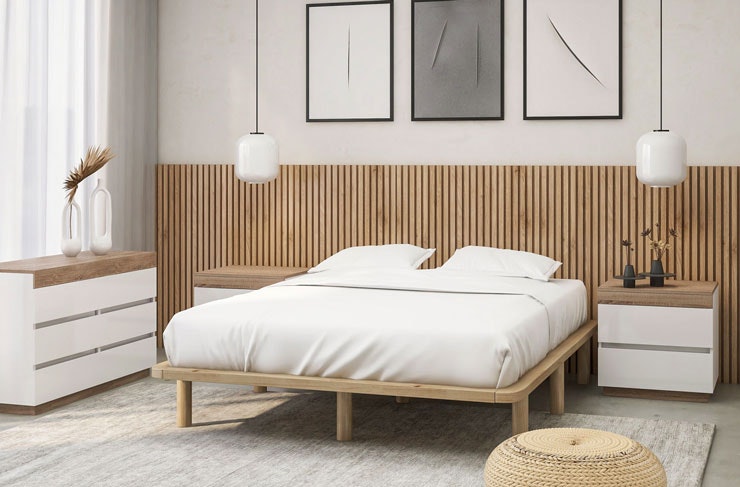 A Scandi-style bedroom, complete with a plush white bed and wooden bed base. 