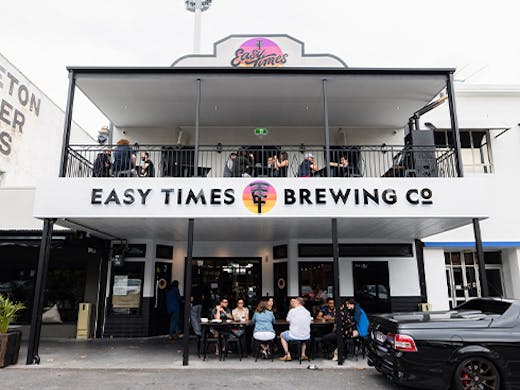 front of two level building with the name Easy Times Brewing Co on the side