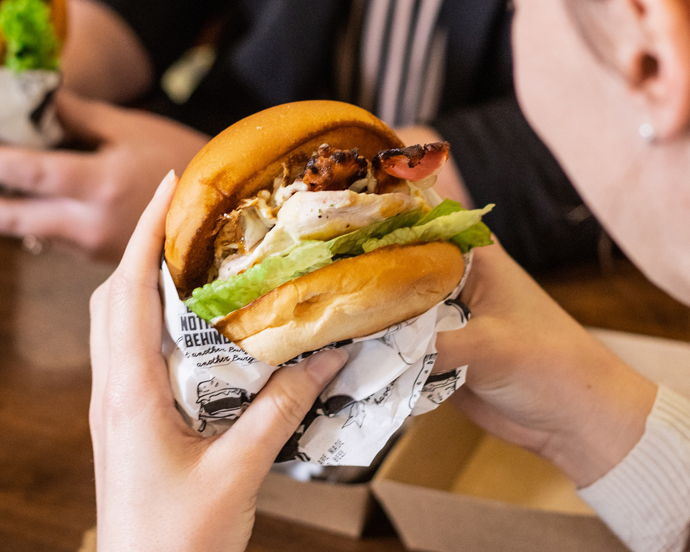 Someone gets ready to tuck into a delicious looking burger at EAT Burger.