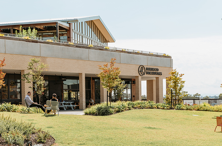 An outdoor food precinct surrounded by green grass.