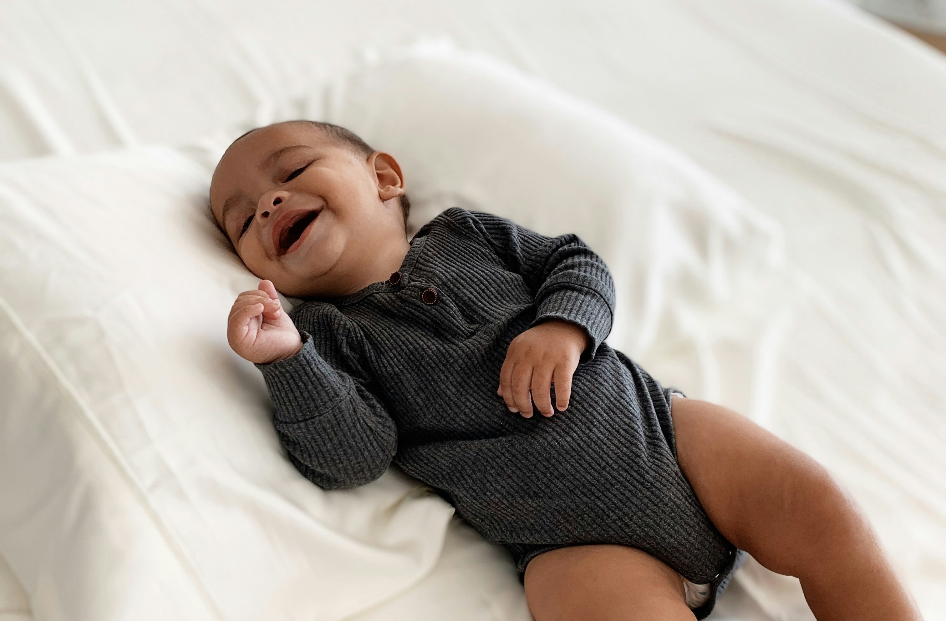 a new born baby sleeps on a mattress 