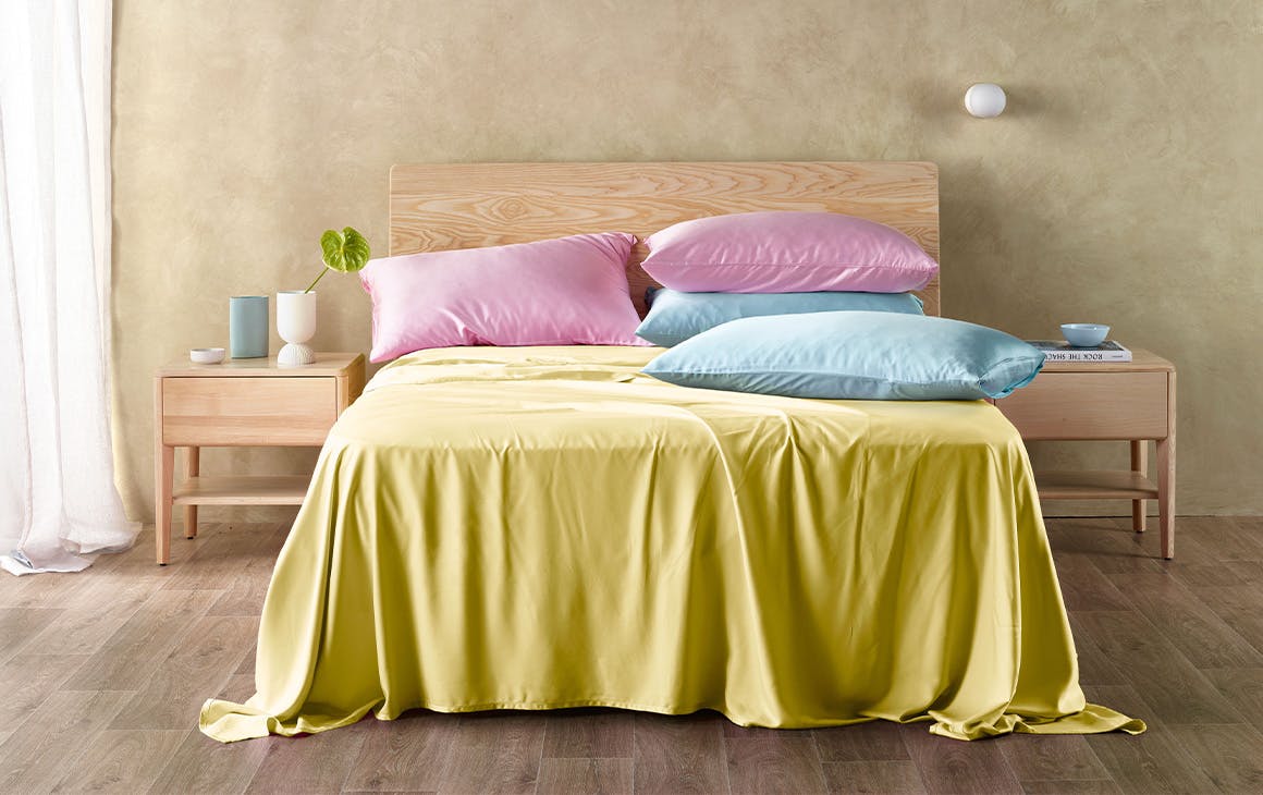 a bed with colourful sheets on it