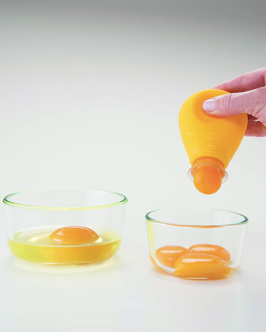 An egg separator that works by removing the yolk in tact.