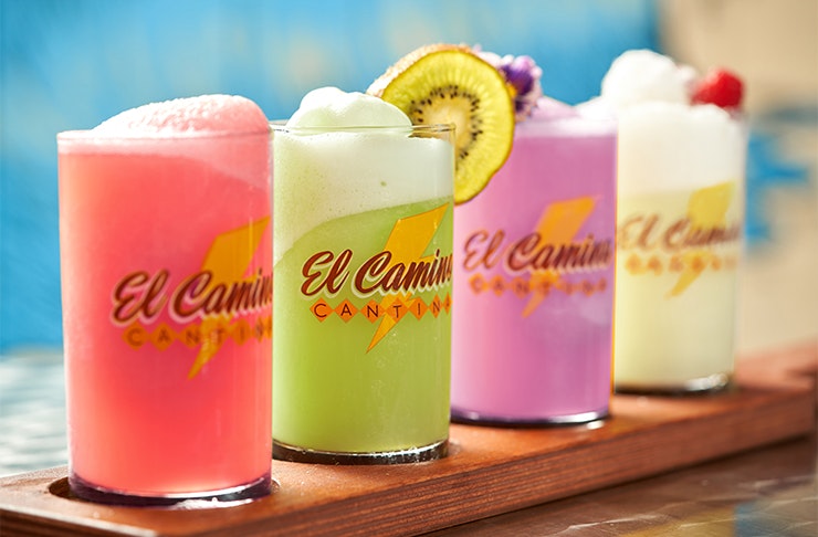 a row of four colourful margaritas