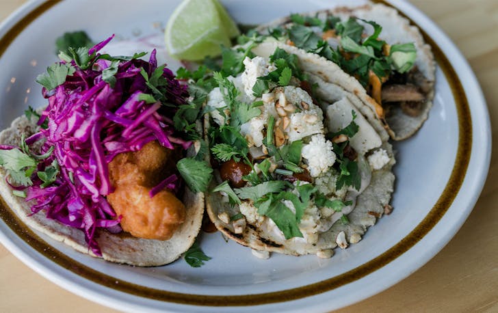 three different vegan tacos on a plate