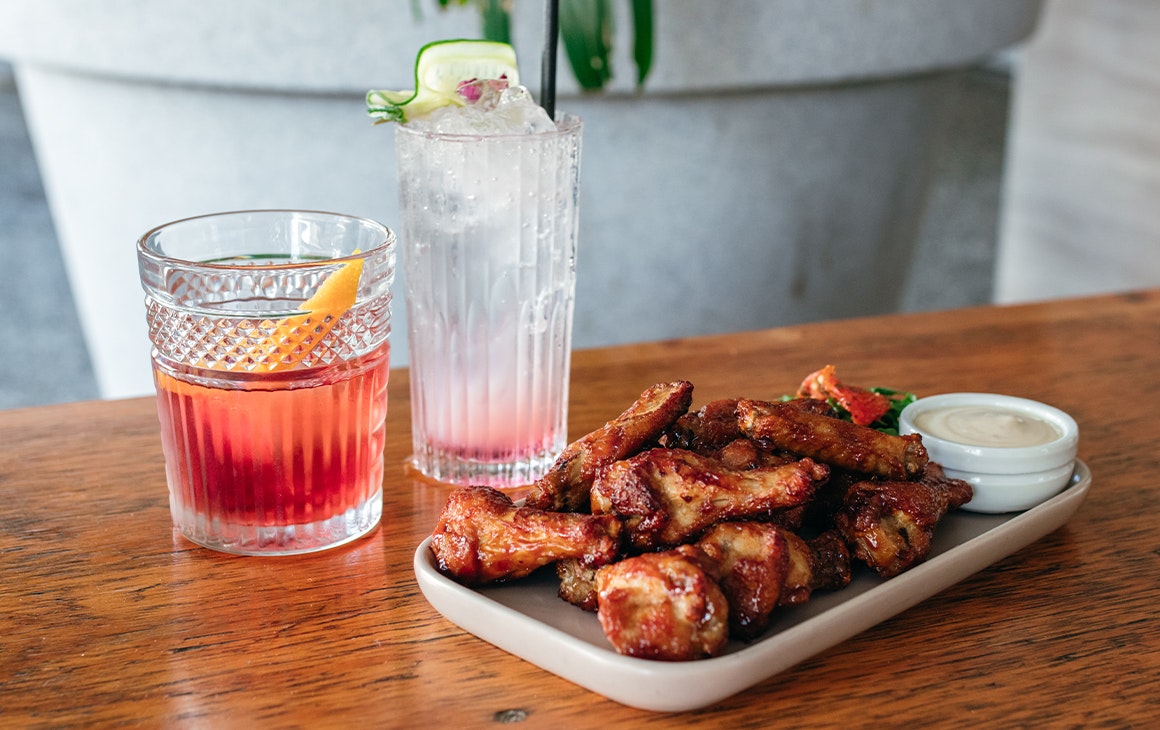 two cocktails and a plate of wings