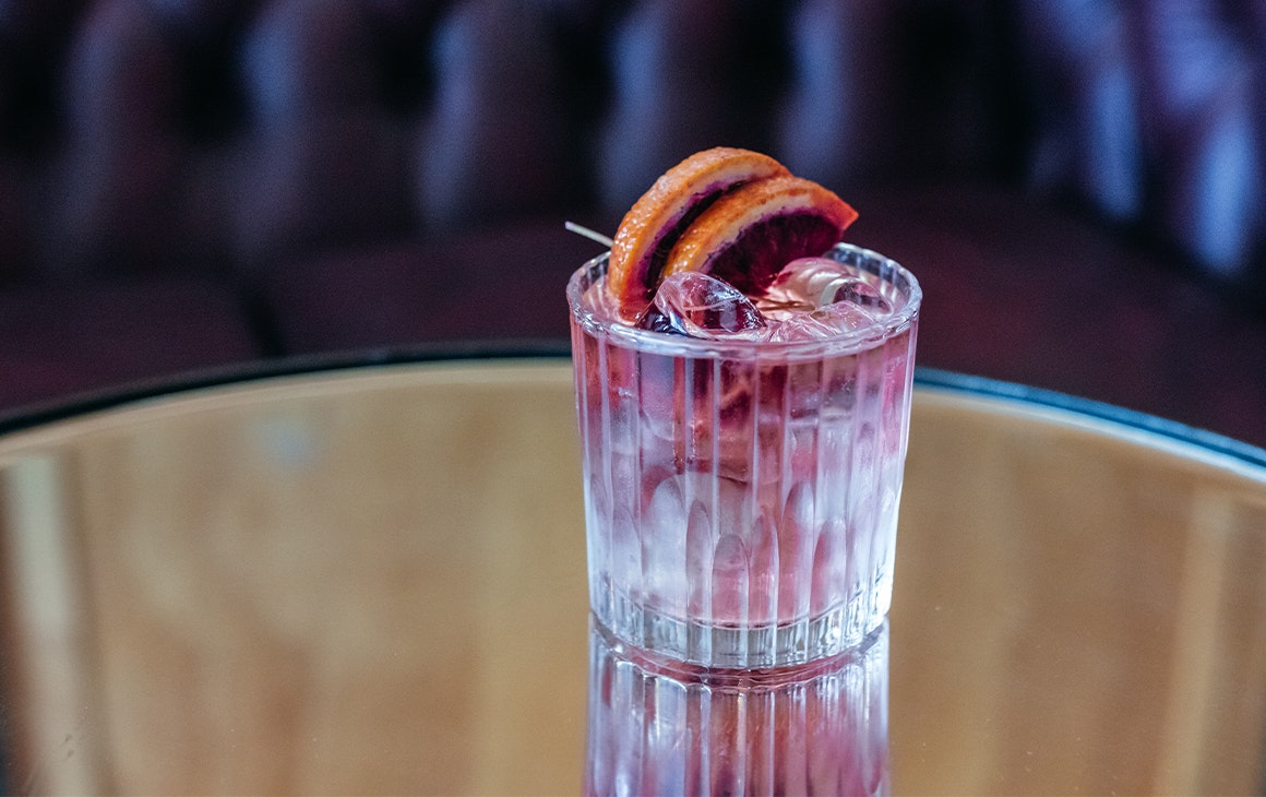 a cocktail on a glass table