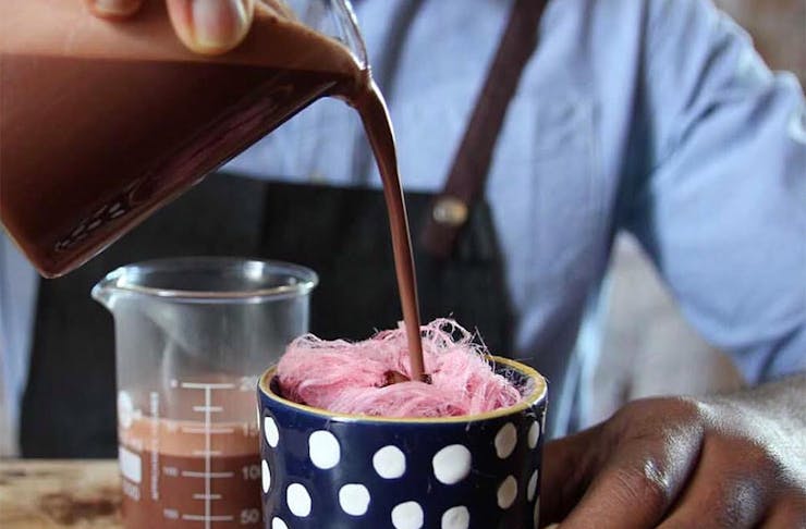 Someone pours a hot chocolate onto candyfloss at Elisabeth's chef in Kingsland.