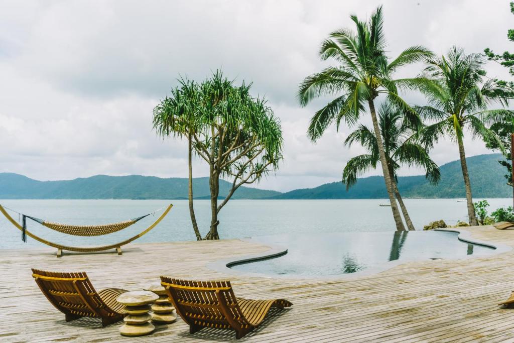 Two chairs overlooking ocean views at  beautiful Queensland Resort, Elysian Luxury Eco Island Retreat
