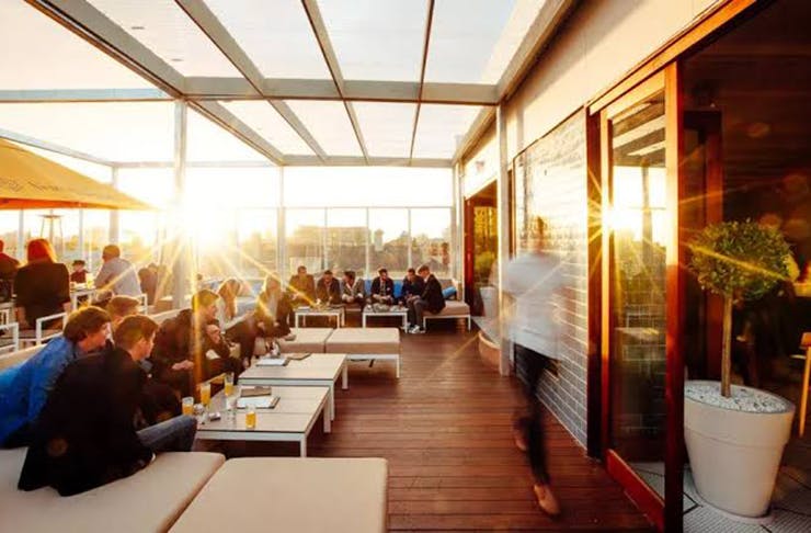 The sun shining over a rooftop bar in Melbourne.