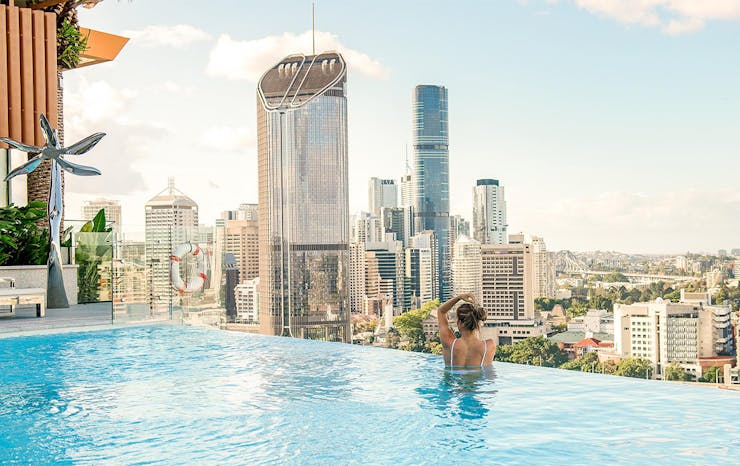 an infinity pool overlooking the brisbane city skyline