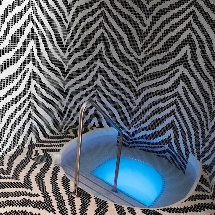 a spa in a tiled bathroom