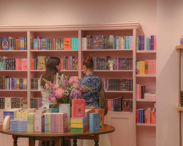 Some people mingle in the warm interiors of Enamoured Books.