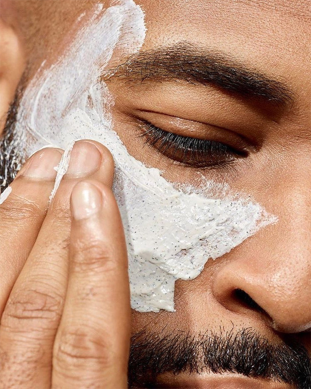 A man applies skincare at Equipoise.