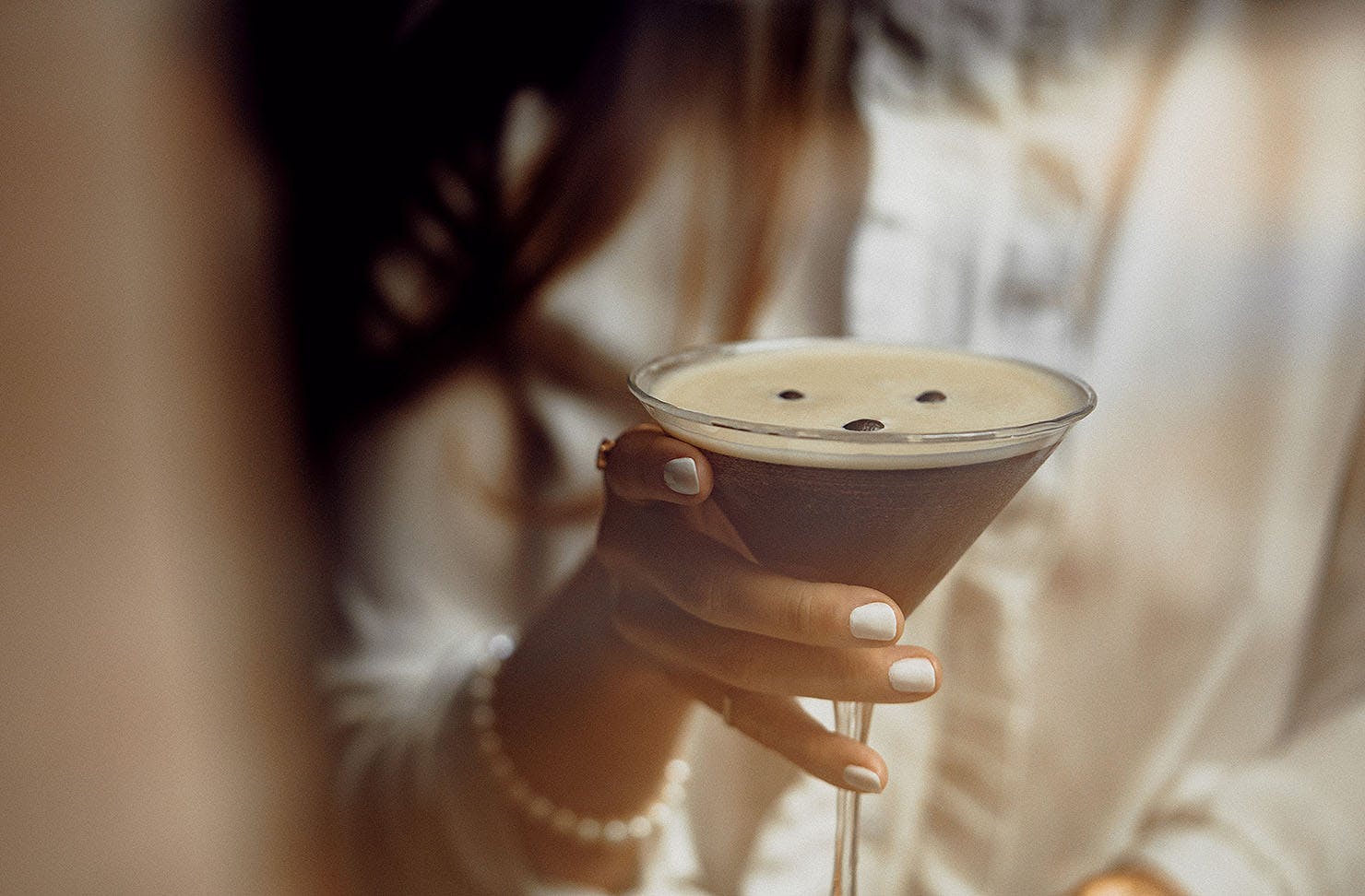 Someone holds an espresso martini