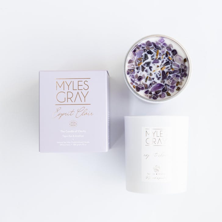 a candle with purple crystals