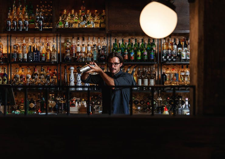 A barman at the bar shaking a cocktail at Esteban Sydney. 