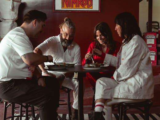 People sit at table at the Ester Spirits Distillery & Tasting Room