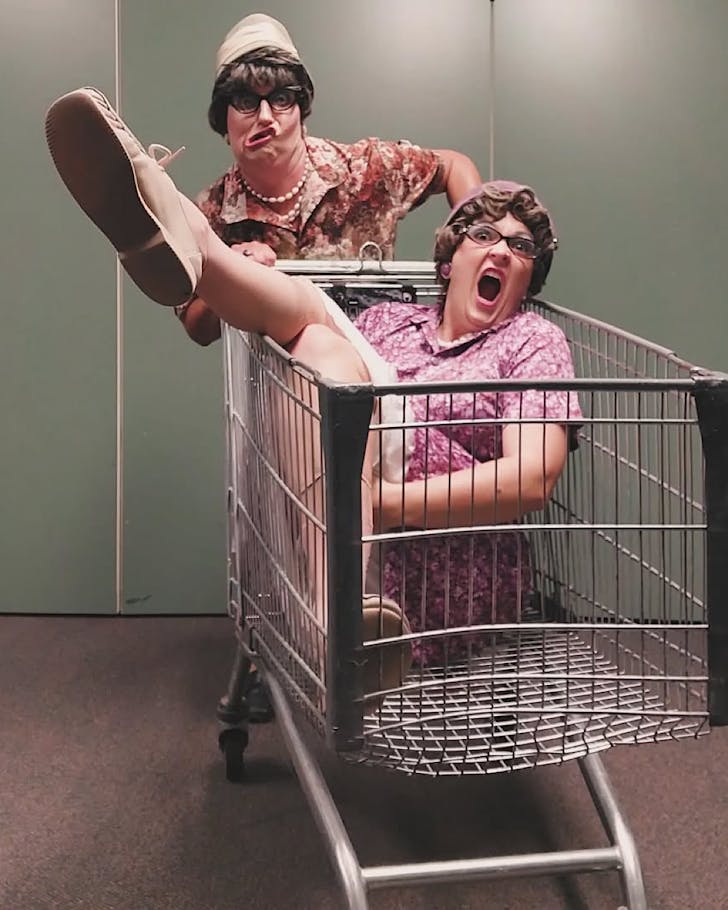 Two vintage-style women wreak havoc in a supermarket trolley.