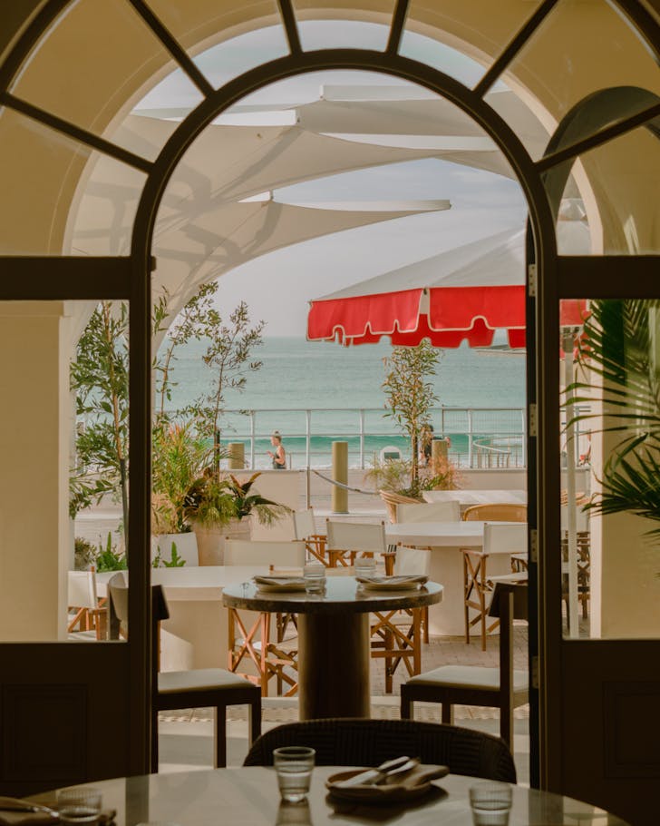 The dining room at Etheus Bondi, with views out to the beach.