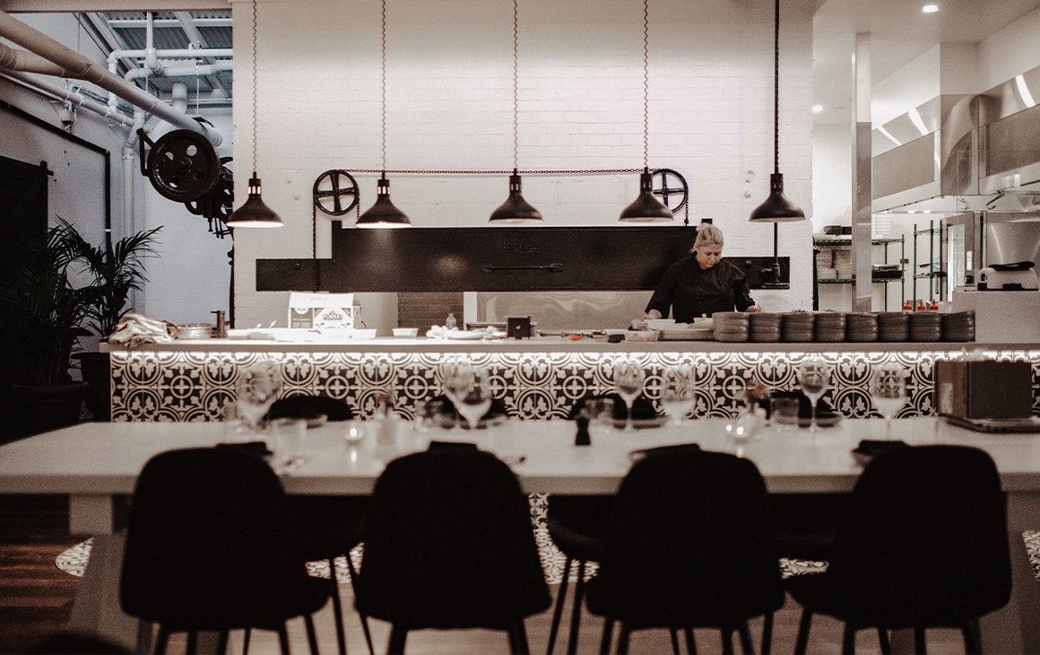 open kitchen visible from dining area at evita