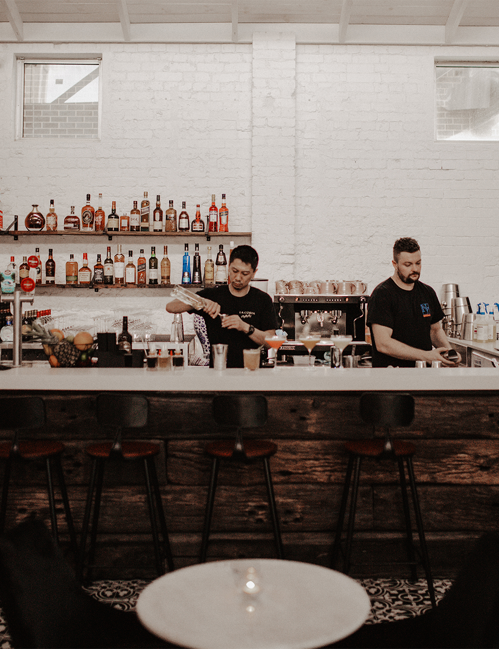 bar at evita, with black and white patterned tiling