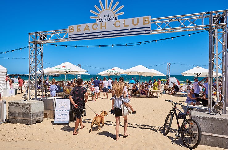 A beach club with a large sign that read 