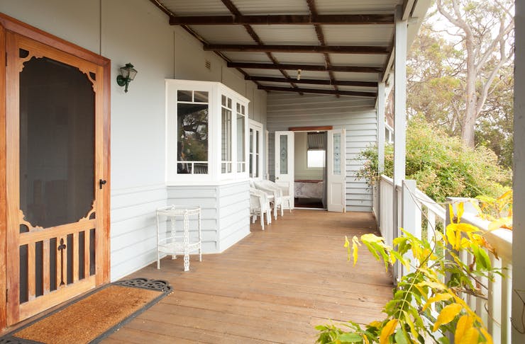 a heritage style verandah overlooking bushland 