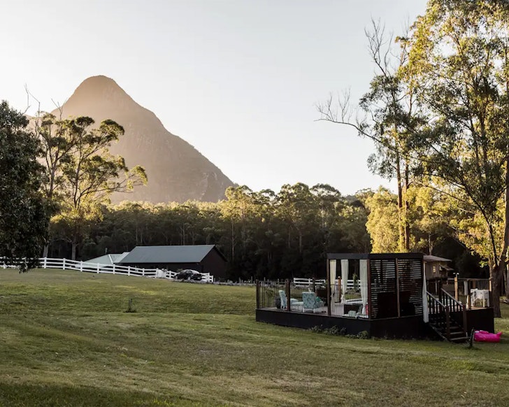 A view of the pool with the Glasshouse mountains in the background at Sunshine Coast Farm Stay one of the best farm stays near Brisbane