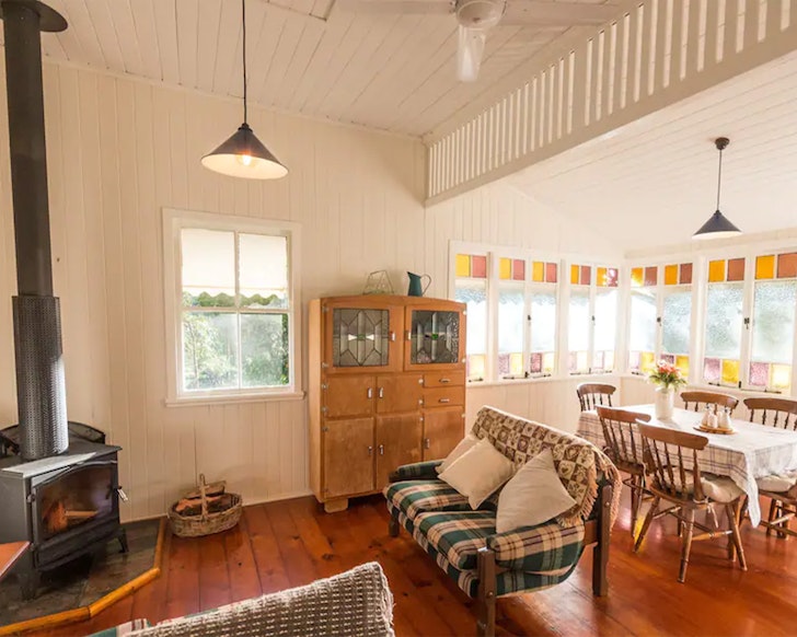 A view of the dining and living space with woodburner at Laceys Creek Homestead one of the best farm stays near Brisbane