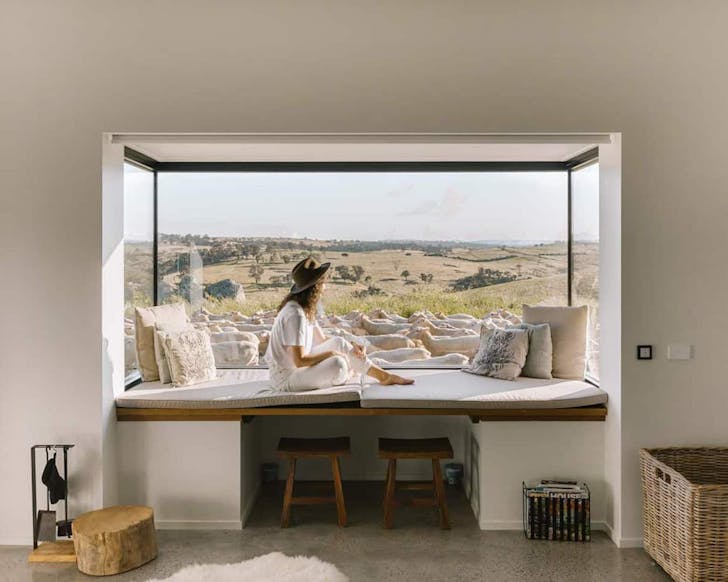 A guest sits in the window of Wilga Station farm stay in NSW