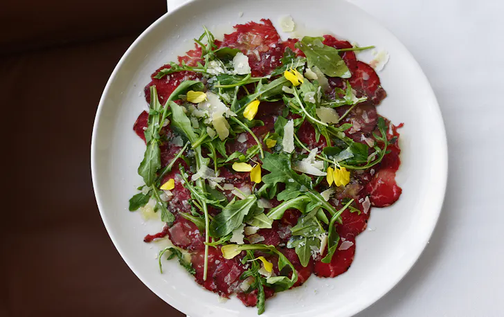a plate of beef carpaccio