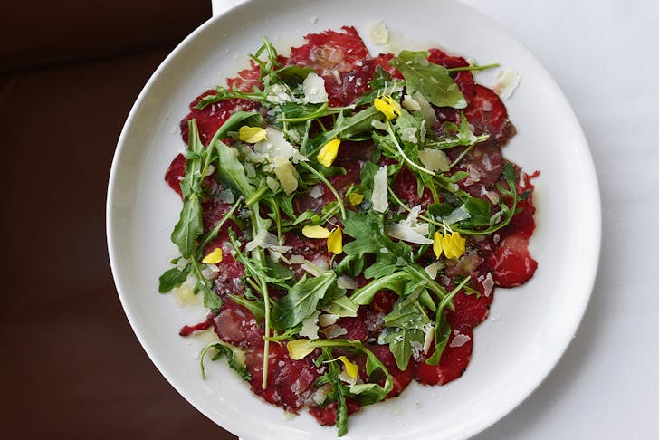 a plate of beef carpaccio