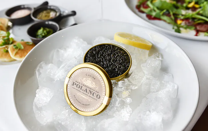 a tin of caviar on a bowl of ice