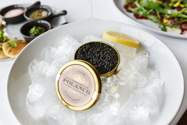a tin of caviar on a bowl of ice