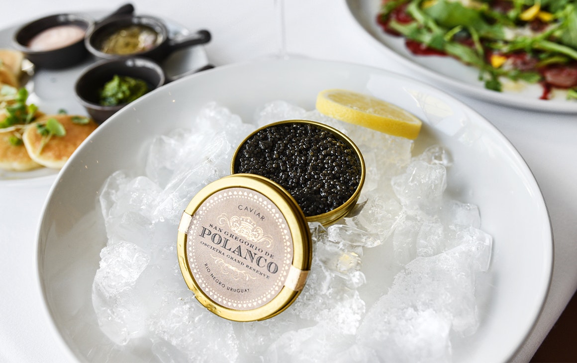 a tin of caviar on a bowl of ice